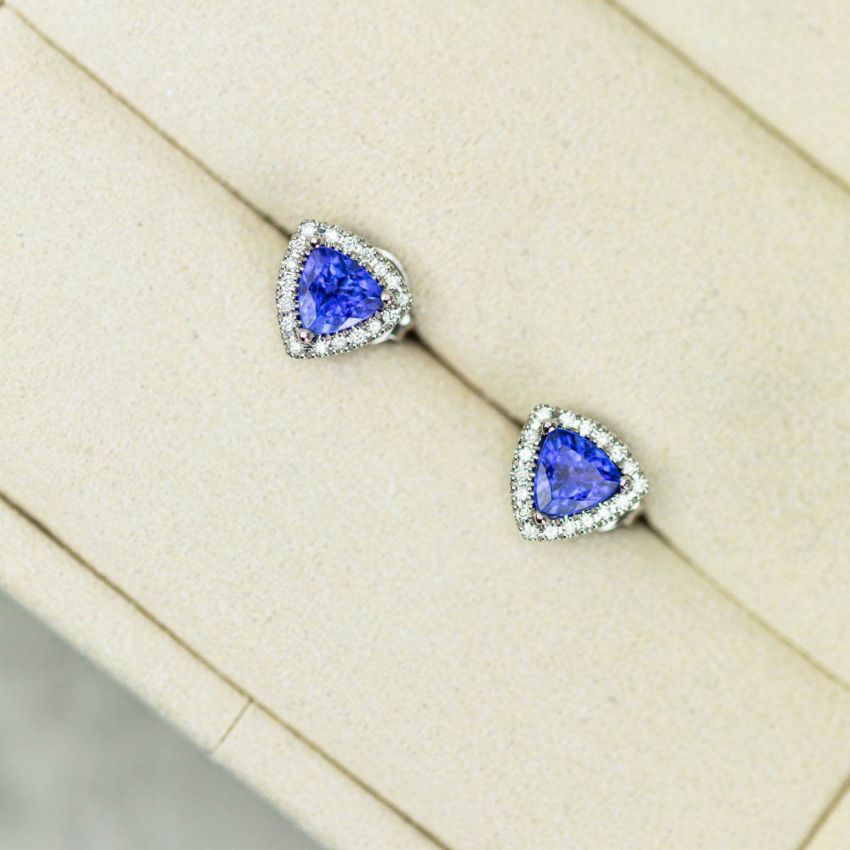 18ct White Gold Trilliant Cut Tanzanite And Diamond Halo Stud Earrings available at RR Jewellers Yarm