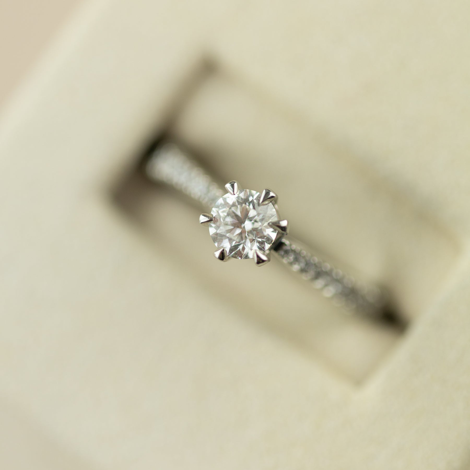 Platinum 0.50ct GIA certificated 6 claw solitaire ring with diamond set shoulders