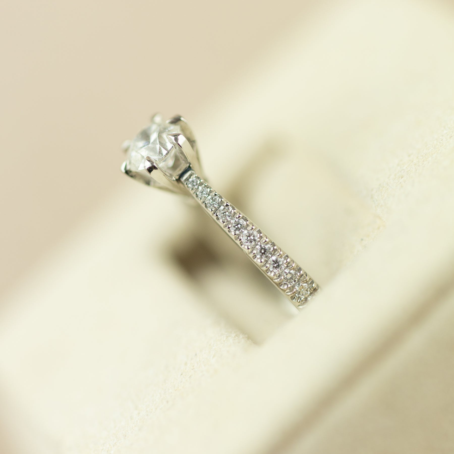 Platinum 0.50ct GIA certificated 6 claw solitaire ring with diamond set shoulders