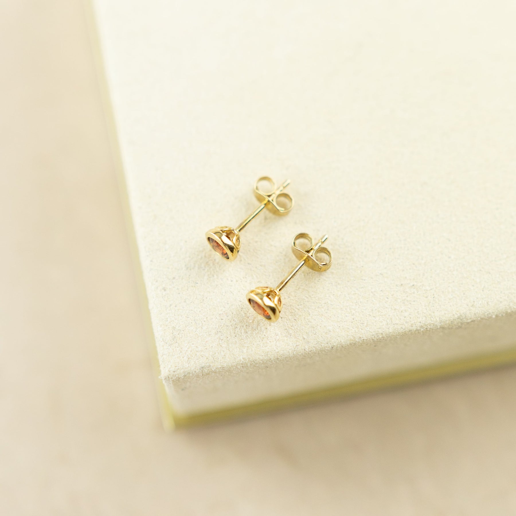 9 Karat Yellow Gold Smooth Bevel Garnet Studs at RR jewellers Yarm UK