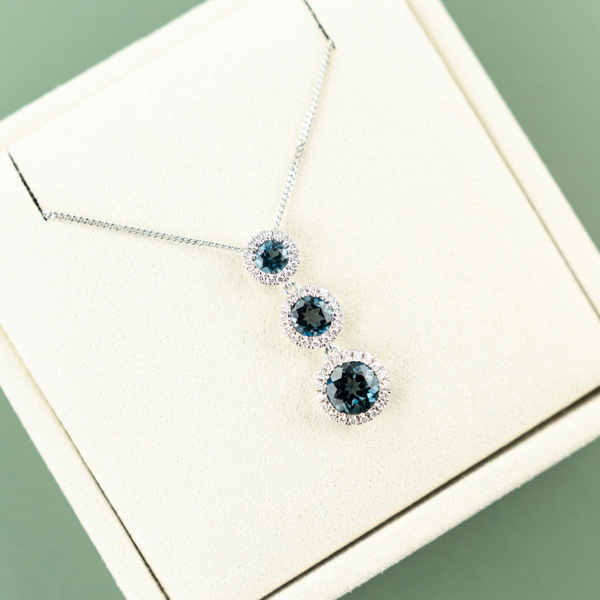 9 Karat White Gold London Blue Drop Halo Pendant