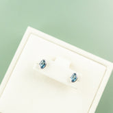 9 Karat White Gold London Blue Topaz Oval Rub Over Earrings