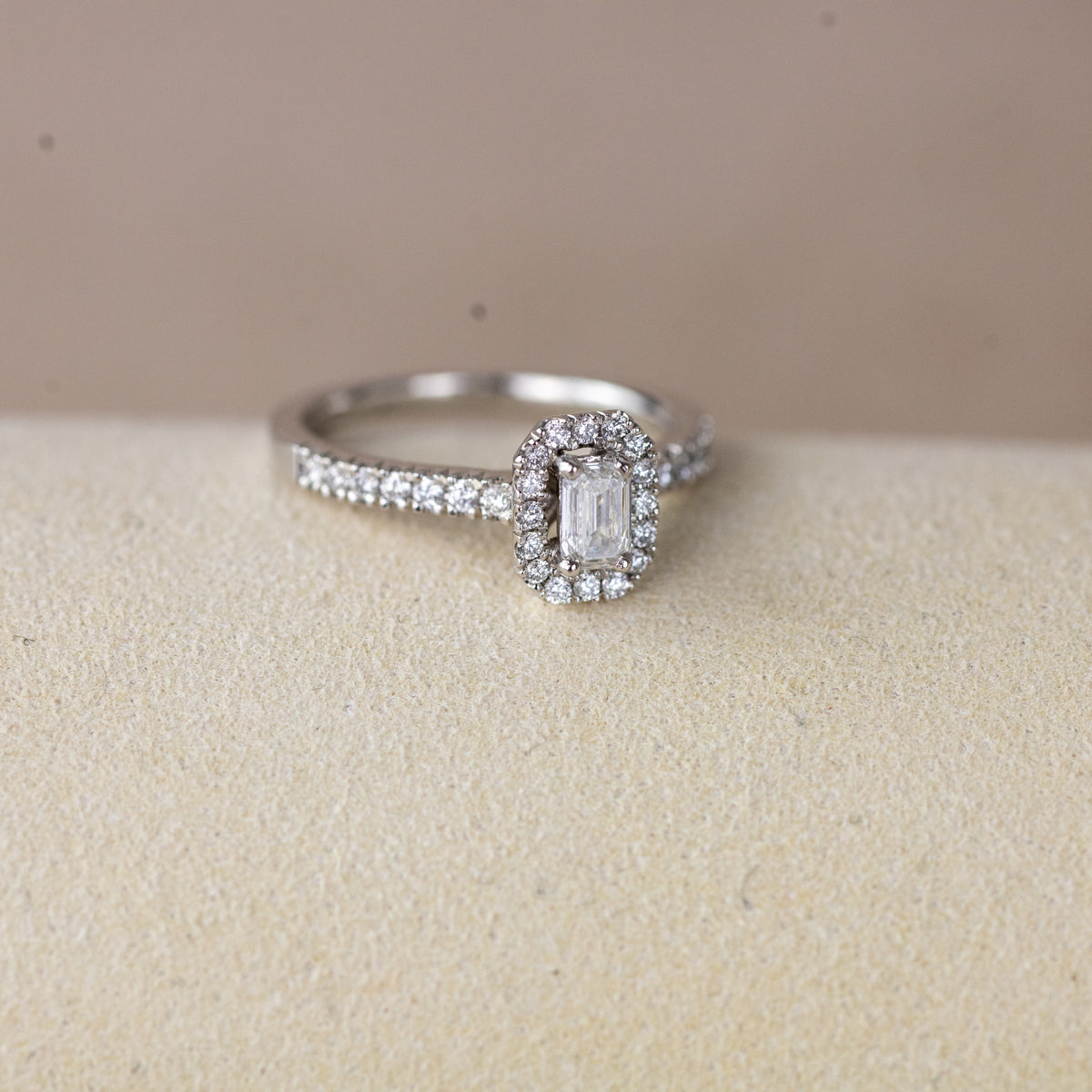 Platinum 0.33ct emerald cut lab diamond halo ring with diamond shoulders