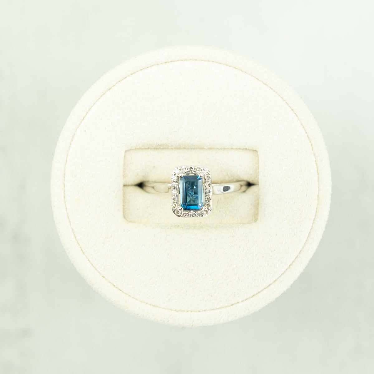 18 Karat White Gold Blue Topaz Emerald Cut Halo Ring at RR Jewellers Yarm