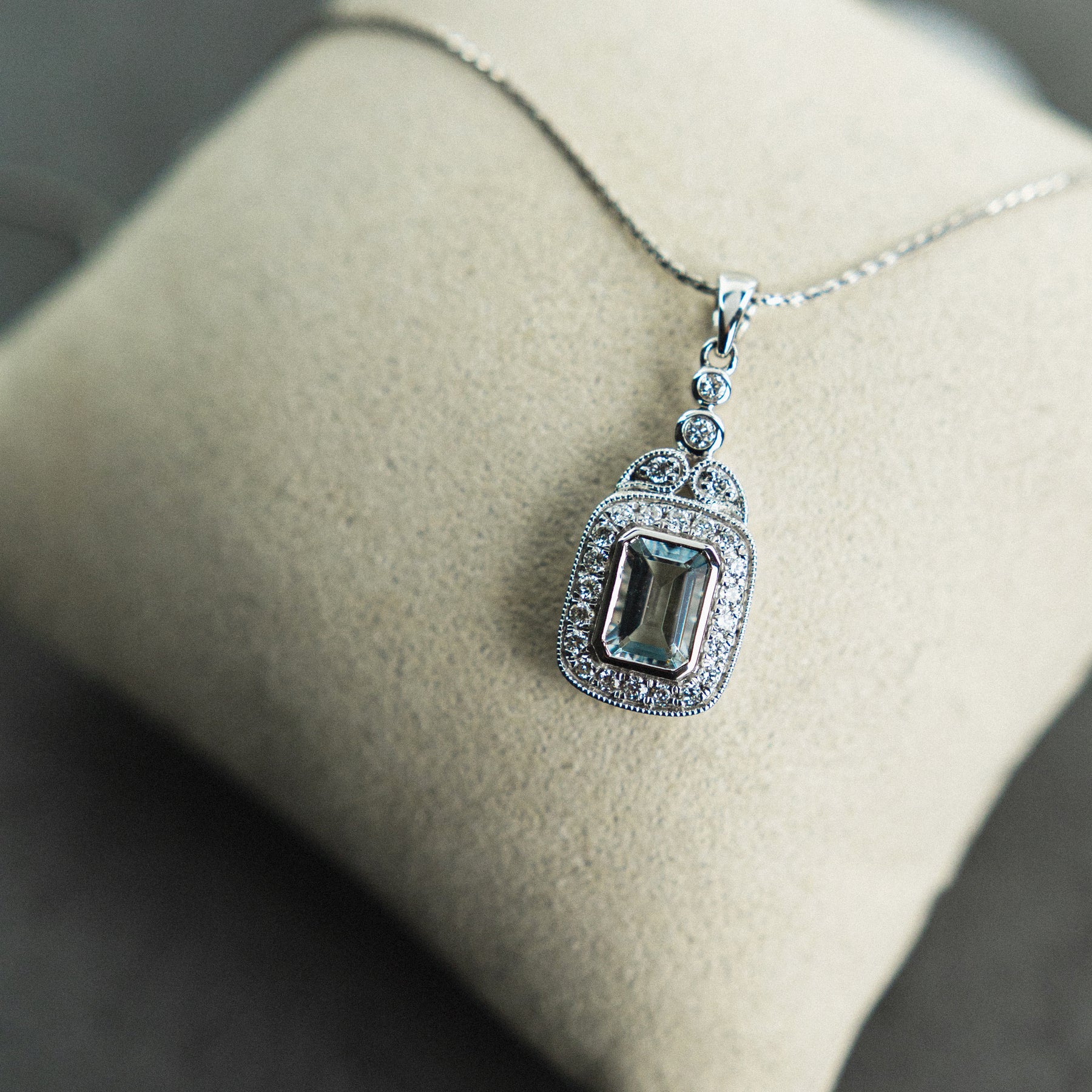 18ct White Gold Emerald Cut Aquamarine & Diamond Halo Pendant available at RR Jewellers Yarm