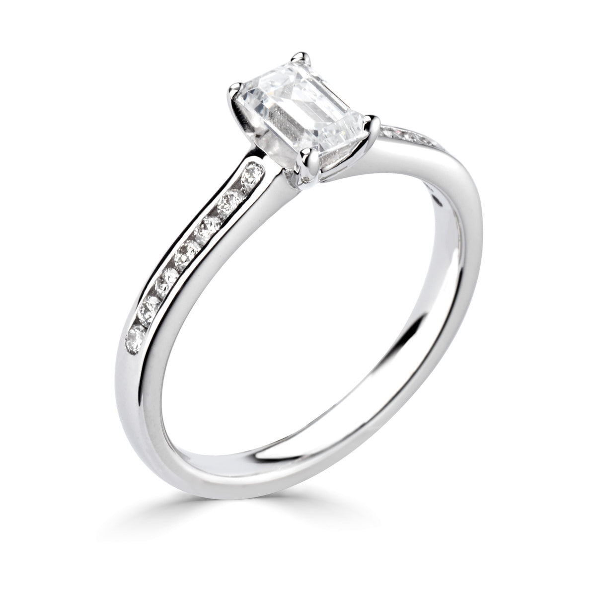 Emerald cut 4 claw diamond channel set ring