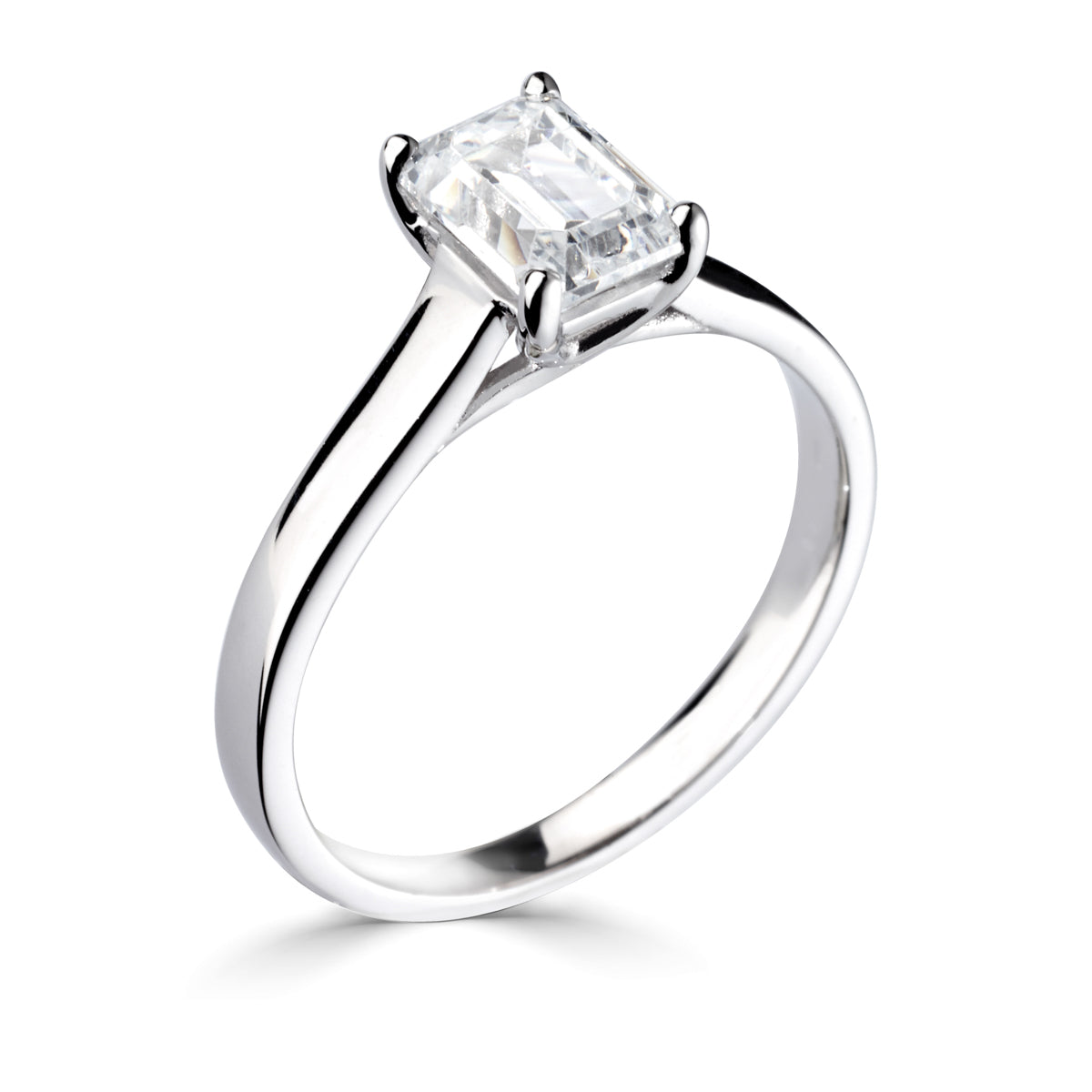 Emerald cut 4 claw diamond crossover ring