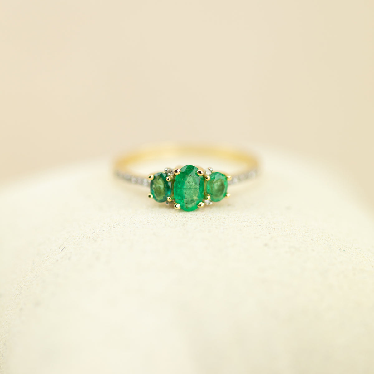 14ct yellow gold 0.60ct Emerald trilogy with 0.10ct diamond set shoulders