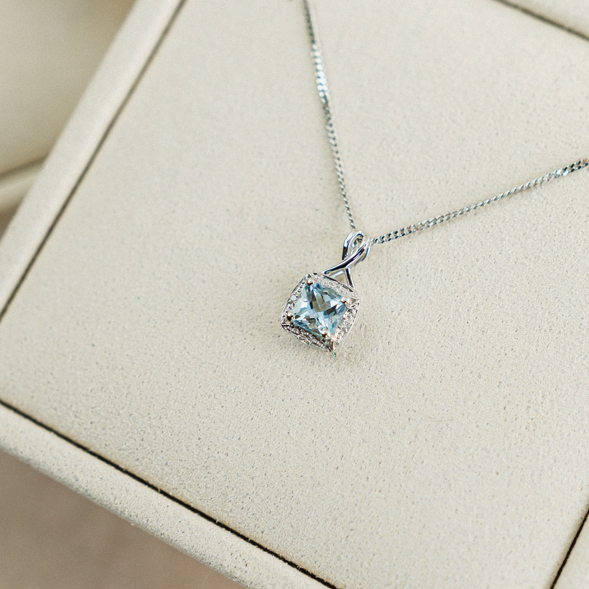 9ct white gold aquamarine and diamond halo twist detail pendant