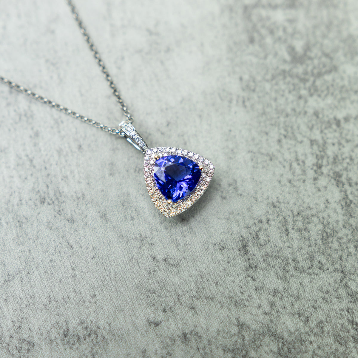 18ct White Gold Trilliant Cut Tanzanite And Diamond Double Halo Pendant At RR Jewellers Yarm