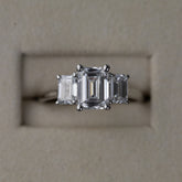 Platinum graduated 2.59ct emerald cut diamond trilogy ring