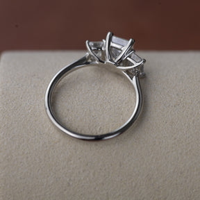 Platinum graduated 2.59ct emerald cut diamond trilogy ring