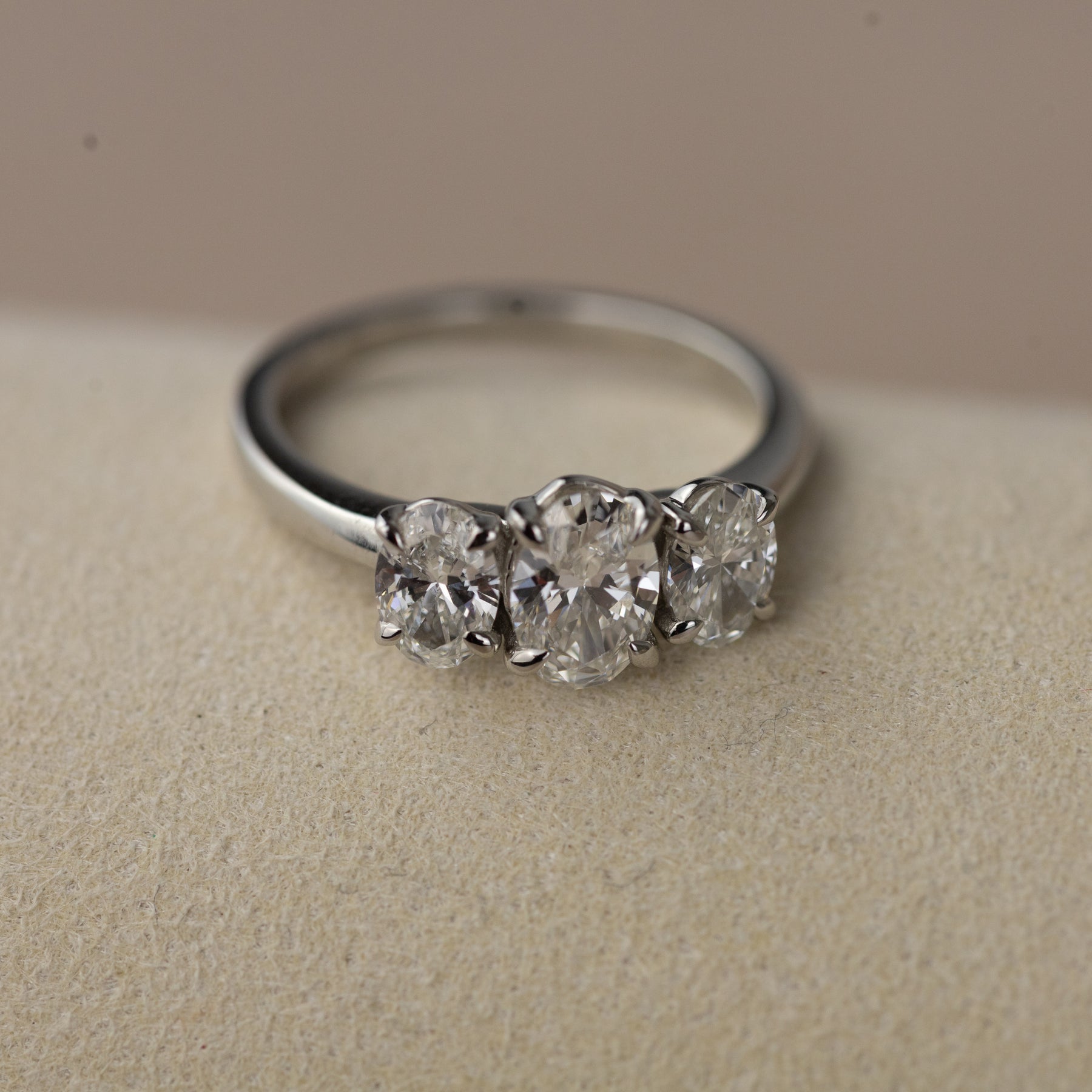 Platinum graduated 1.50ct oval cut trilogy ring