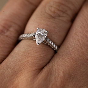 Platinum pear cut 0.70ct solitaire ring with diamond set shoulders