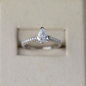 Platinum pear cut 0.70ct solitaire ring with diamond set shoulders