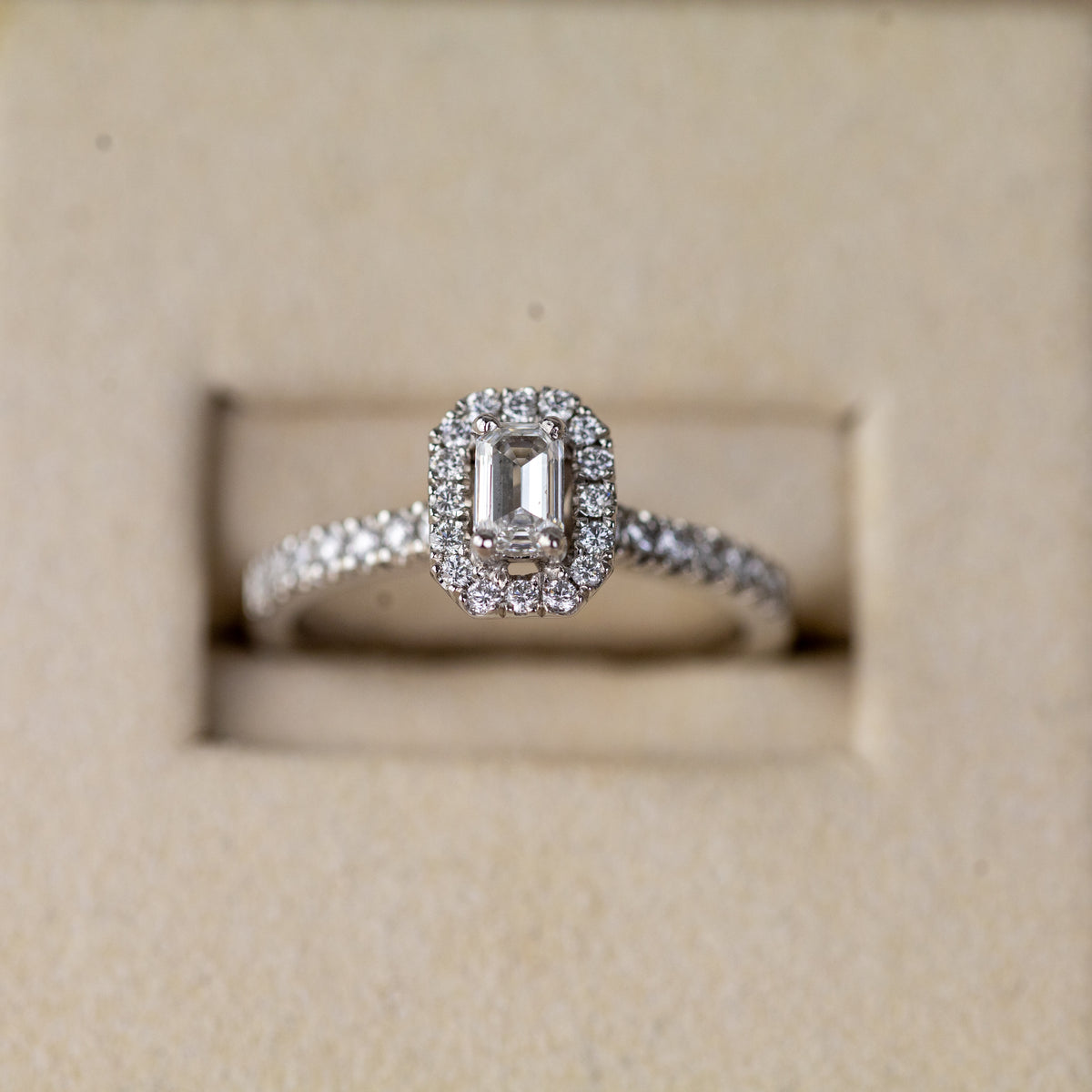 Platinum 0.33ct emerald cut lab diamond halo ring with diamond shoulders