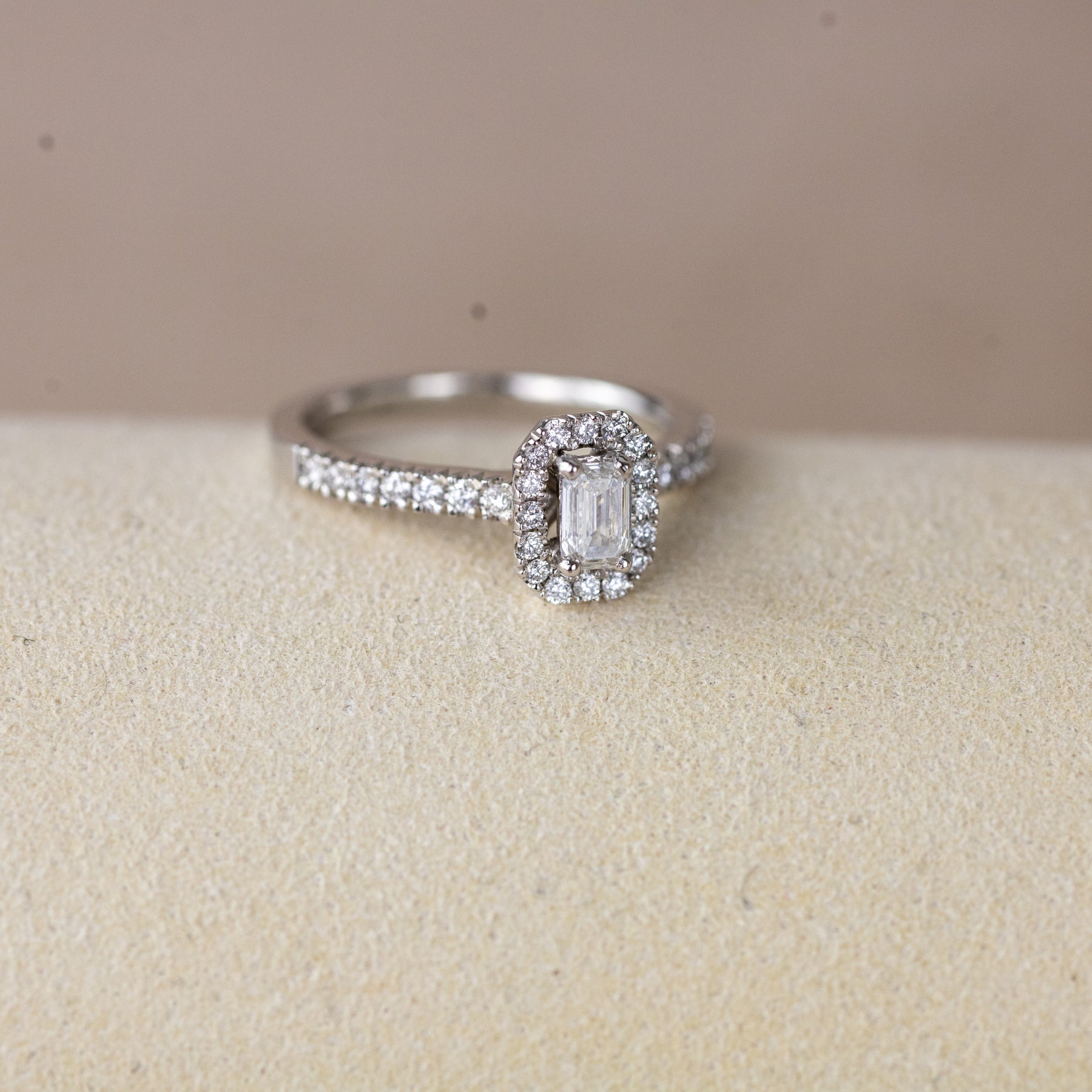 Platinum 0.33ct emerald cut lab diamond halo ring with diamond shoulders