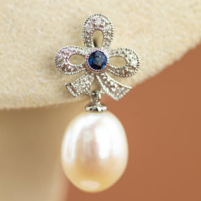 Freshwater Pearl & Sapphire Bow Earring in 9 Karat White Gold at RR Jewellers UK