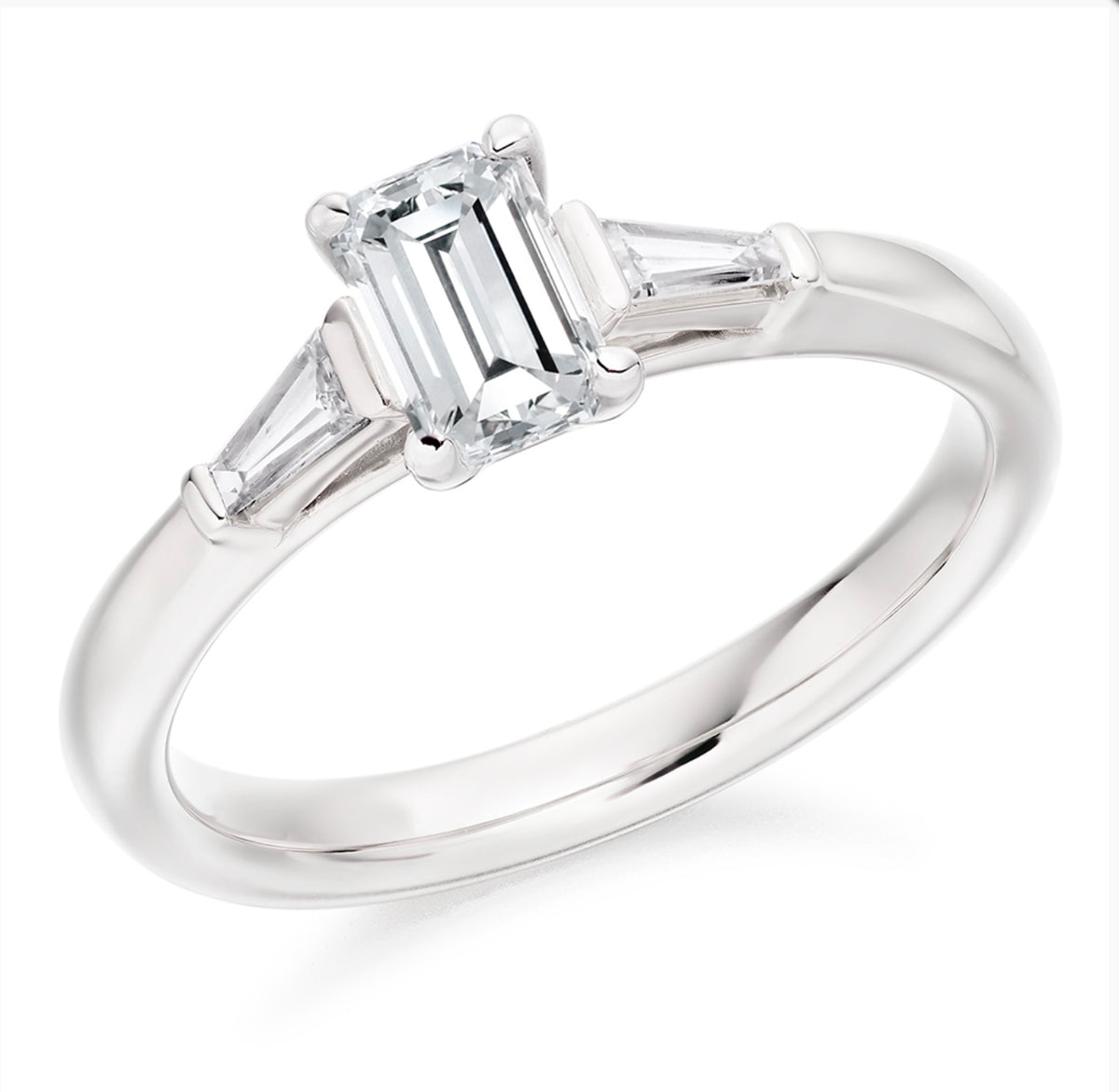 Platinum emerald cut diamond trilogy ring